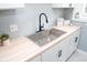 Modern kitchen sink with matte black faucet, wood countertop, and white shaker cabinets at 3723 N Olney St, Indianapolis, IN 46218