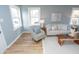 Living room featuring neutral tones, comfortable seating, and sleek hardwood floors at 3723 N Olney St, Indianapolis, IN 46218