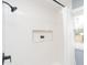 This shower features white subway tile, a built-in niche, and a black shower head at 3723 N Olney St, Indianapolis, IN 46218