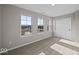 Carpeted bedroom featuring three windows and closet with sliding doors at 4160 Douro Trl, Westfield, IN 46062