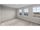 This carpeted bedroom is bright and airy, thanks to its three windows with exterior views at 4160 Douro Trl, Westfield, IN 46062
