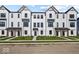 Beautiful townhomes showing modern farmhouse design with white siding and dark trim accents at 4160 Douro Trl, Westfield, IN 46062