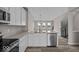 Modern kitchen featuring stainless steel appliances, white cabinets, and open layout at 4160 Douro Trl, Westfield, IN 46062