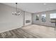 Spacious living room featuring modern lighting, wood floors, and bright windows at 4160 Douro Trl, Westfield, IN 46062