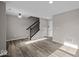 Bright living room boasts hardwood floors, neutral paint, and staircase to the second floor at 4160 Douro Trl, Westfield, IN 46062