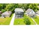 Aerial view of a two-story home with a well-manicured lawn and mature trees at 4242 Winthrop Ave, Indianapolis, IN 46205
