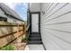 Cozy back entrance featuring a secure white door, dark steps, and a manicured lawn at 4242 Winthrop Ave, Indianapolis, IN 46205