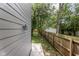 Serene backyard featuring a wooden fence for privacy, a grassy lawn, and mature shade trees at 4242 Winthrop Ave, Indianapolis, IN 46205