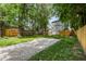 Expansive backyard with lush greenery, mature trees, and a charming gravel area at 4242 Winthrop Ave, Indianapolis, IN 46205