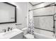 Updated bathroom with marble tile, modern fixtures, and a shower-tub combination at 4242 Winthrop Ave, Indianapolis, IN 46205