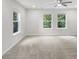 Bright and airy bedroom with neutral walls, carpet, and three large windows at 4242 Winthrop Ave, Indianapolis, IN 46205
