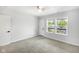 Cozy bedroom with new carpet, ceiling fan, and a door to a balcony with neighborhood views at 4242 Winthrop Ave, Indianapolis, IN 46205