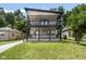 Charming two-story home featuring a spacious double-decker porch with stylish black railings and a well-maintained lawn at 4242 Winthrop Ave, Indianapolis, IN 46205