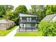 Charming two-story home featuring a spacious double-decker porch with stylish black railings and a well-maintained lawn at 4242 Winthrop Ave, Indianapolis, IN 46205