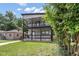 Charming two-story home featuring a spacious double-decker porch with stylish black railings and a well-maintained lawn at 4242 Winthrop Ave, Indianapolis, IN 46205