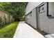 Grey brick house with a clean driveway and a grassy lawn, landscaped for curb appeal at 4242 Winthrop Ave, Indianapolis, IN 46205