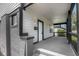 Inviting front porch with stylish lighting fixtures and brick detailing, creating a warm and welcoming entrance at 4242 Winthrop Ave, Indianapolis, IN 46205