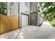 Spacious two car garage with a concrete driveway and a wooden fence on a sunny day at 4242 Winthrop Ave, Indianapolis, IN 46205