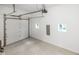 Clean garage with white walls, two windows, and sealed concrete floor at 4242 Winthrop Ave, Indianapolis, IN 46205