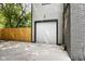 Bright two car garage with concrete driveway and wooden fence, adding secure parking at 4242 Winthrop Ave, Indianapolis, IN 46205