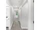 Bright hallway featuring sleek gray floors, crisp white walls, and doors leading to various rooms at 4242 Winthrop Ave, Indianapolis, IN 46205