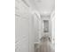 Well-lit hallway with gray wood floors, fresh paint, and closet space at 4242 Winthrop Ave, Indianapolis, IN 46205