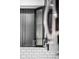 This kitchen features modern dark cabinets, glass shelving, and sleek hardware at 4242 Winthrop Ave, Indianapolis, IN 46205