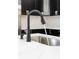 Close-up of a modern kitchen sink featuring a sleek faucet with running water at 4242 Winthrop Ave, Indianapolis, IN 46205