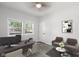 Well-lit home office featuring a spacious desk, comfortable seating, and a bright window at 4242 Winthrop Ave, Indianapolis, IN 46205
