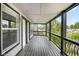 Spacious, covered patio with wood floor and ornamental metal railing at 4242 Winthrop Ave, Indianapolis, IN 46205