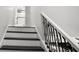 Staircase features neutral walls and black and white color scheme at 4242 Winthrop Ave, Indianapolis, IN 46205