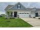 Charming home featuring a two-car garage, and a well-manicured front lawn at 50 Hovden Dr, Cicero, IN 46034
