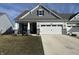 Charming home featuring a two car garage, stone accents, and a well-manicured lawn at 50 Hovden Dr, Cicero, IN 46034