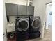Well-equipped laundry room featuring front-load washer and dryer, utility sink, and ample storage at 50 Hovden Dr, Cicero, IN 46034