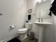 Bright powder room with pedestal sink, modern toilet, and stylish decor at 50 Hovden Dr, Cicero, IN 46034