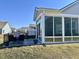 View of sunroom with floor-to-ceiling windows, outdoor patio seating, and backyard at 50 Hovden Dr, Cicero, IN 46034