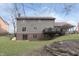 Exterior view of the back of house with patio, deck, and lush green lawn at 504 Stony Creek Cir, Noblesville, IN 46060