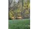 Scenic backyard overlooking a tranquil creek, offering a serene view surrounded by nature and lush greenery at 504 Stony Creek Cir, Noblesville, IN 46060