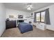 Bright bedroom with a window seat, ceiling fan, and dark wood furnishings at 504 Stony Creek Cir, Noblesville, IN 46060