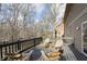 Wooden deck with seating overlooking a backyard creek and woods at 504 Stony Creek Cir, Noblesville, IN 46060