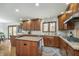 Modern kitchen featuring wooden cabinets, granite countertops, and stainless steel appliances at 504 Stony Creek Cir, Noblesville, IN 46060