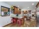 Well-equipped kitchen with granite countertops, wooden cabinetry, and stainless steel appliances at 504 Stony Creek Cir, Noblesville, IN 46060