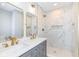 Elegant bathroom boasts a double vanity with gold accents, marble tile shower, and stylish lighting at 520 N Parker Ave, Indianapolis, IN 46201