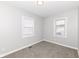 Neutral bedroom with two windows, carpet flooring and fresh paint ready for personalization at 520 N Parker Ave, Indianapolis, IN 46201