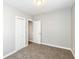 Bedroom with neutral walls and carpet flooring, featuring a closet and an open doorway at 520 N Parker Ave, Indianapolis, IN 46201