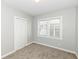 Bright bedroom featuring neutral walls, carpet flooring, and a closet with a window for natural light at 520 N Parker Ave, Indianapolis, IN 46201