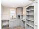 Updated kitchen area features gray cabinets, subway backsplash, granite counters, and wood look ceramic tile at 520 N Parker Ave, Indianapolis, IN 46201