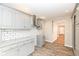 Bright kitchen features shaker cabinets, granite counters, subway tile backsplash, and wood-look tile flooring at 520 N Parker Ave, Indianapolis, IN 46201