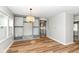 Bright living room featuring hardwood floors, custom built-ins, and a view into the kitchen at 520 N Parker Ave, Indianapolis, IN 46201