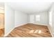 Large living room featuring hardwood floors, recessed lighting, and a bright entry door at 520 N Parker Ave, Indianapolis, IN 46201